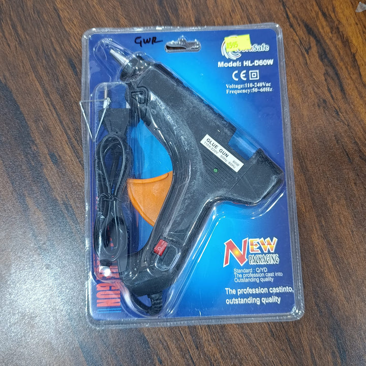 Hot glue gun in packaging on a wooden surface