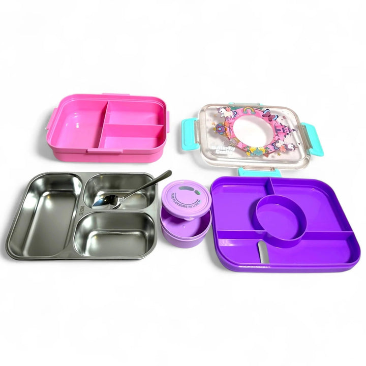 Collection of colorful lunch containers including pink, purple, and silver on a white background
