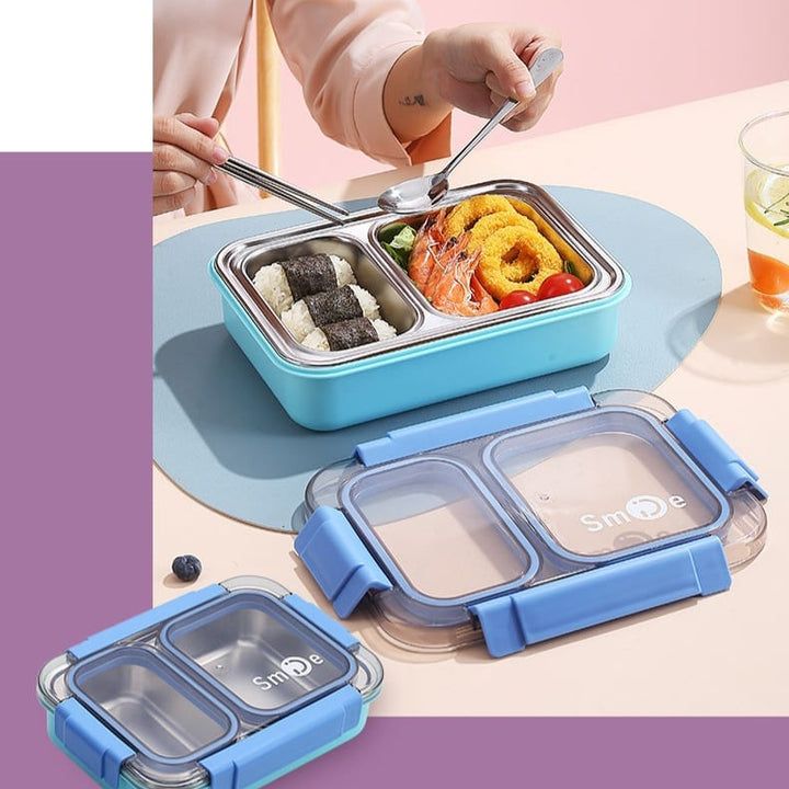Blue bento box with compartments filled with food, on a pink background