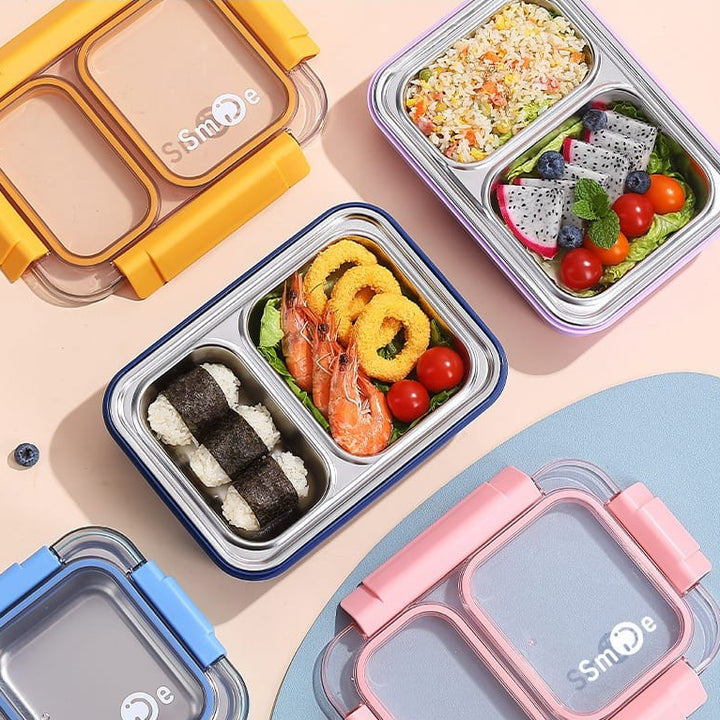 Assorted bento boxes with food compartments on a light pink background