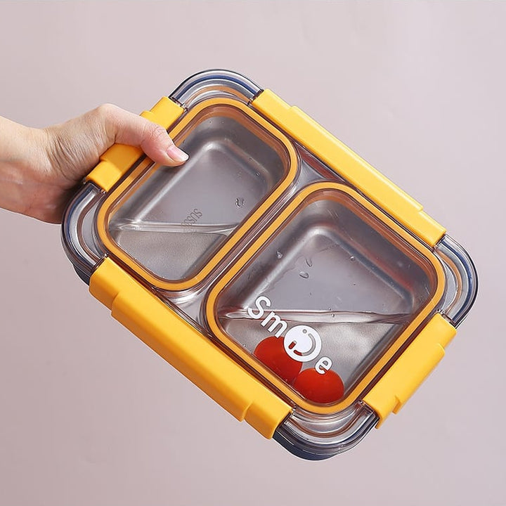 Yellow and silver food container with a hand holding it on a light gray background