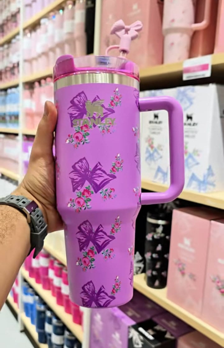 Purple children's thermos with handle held in front of a store shelf.