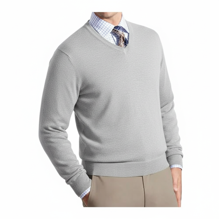 Gray sweater over a checkered shirt with beige pants on a white background
