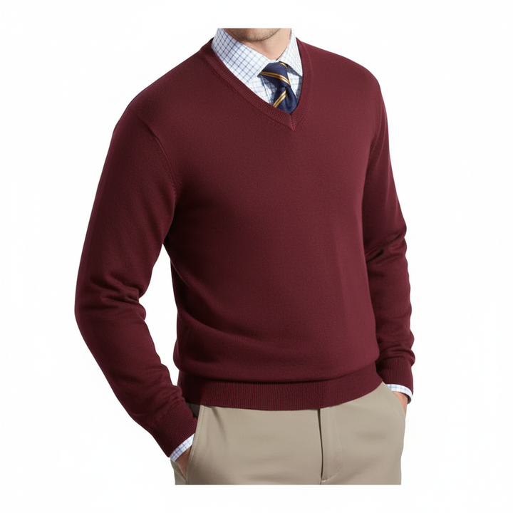 Maroon sweater over a checkered shirt with a tie, paired with beige pants on a white background
